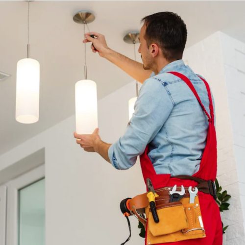 property maintenance services - man changing a light fiting.