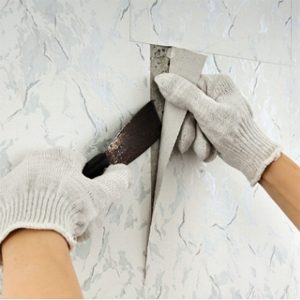 handyman removing wallpaper