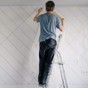 A London handyman up a ladder