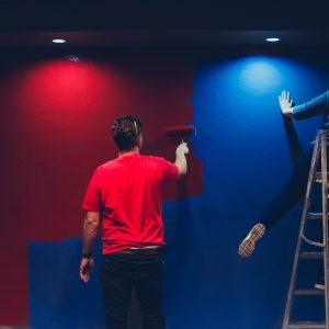 a London handyman and an odd job guy painting a wall